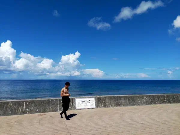 Scuba diving: On the seawall, wetsuit half off.