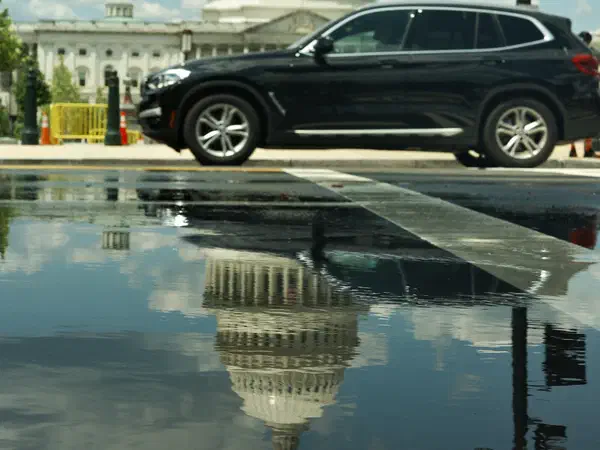 Photography: The Capitol reflected in a puddle after the rain, Washington, D.C.