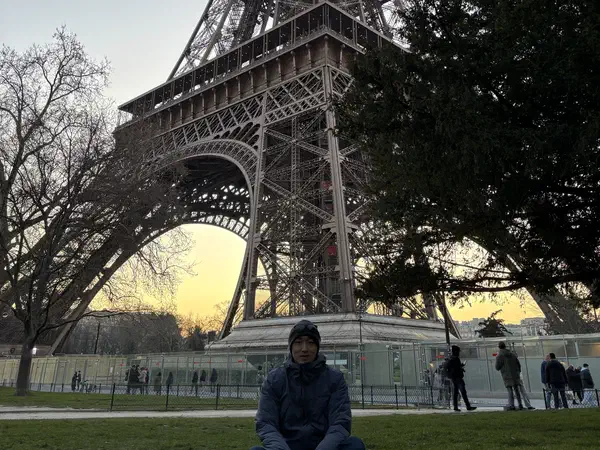 Paris, France: The Eiffel Tower from the Champ de Mars at dusk.