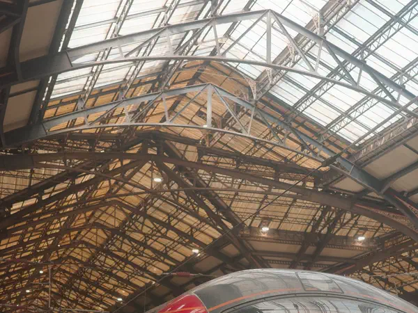Paris, France: A train waiting under the iron and glass of a Paris terminus.