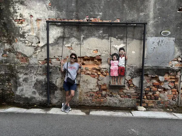 Penang, Malaysia: On a street-art swing in George Town.