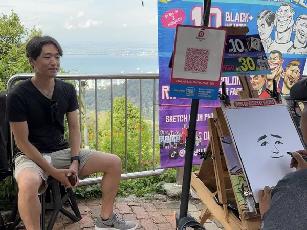 Penang, Malaysia: Getting a caricature drawn on Penang Hill.